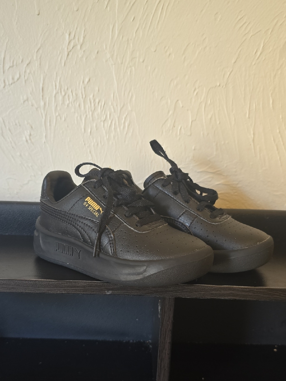 Puma Kids Black Low-Top Sneakers with Subtle Gold Logo